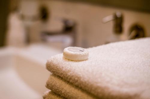 a white towel with a button on top of it at Balokány apartman in Pécs