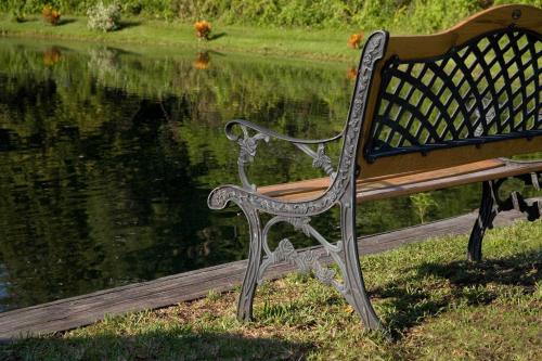 a park bench sitting next to a body of water at Sleep Inn Jacksonville Airport in Jacksonville