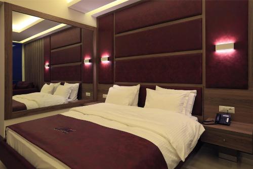 a bedroom with a large bed and a mirror at Ibiza Hotel in Jounieh
