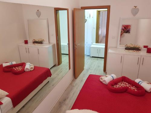 a bedroom with two beds and a mirror at Apartment GEA 1 in Novi Sad