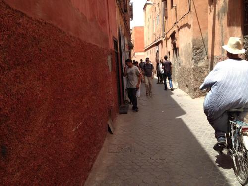 a group of people walking down a narrow alley at Riad Charme d'Orient Adults Only in Marrakech