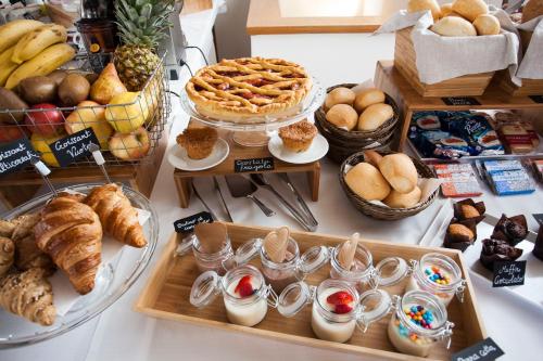 a table with various types of bread and pastries at Casa Alla Lega in Arco