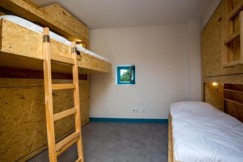 a bedroom with two bunk beds and a bed at Des Arts in Amarante