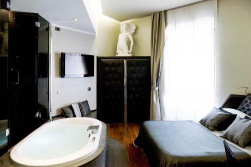 a bedroom with a bed and a tub in it at Le Stanze Di Federica in Rome