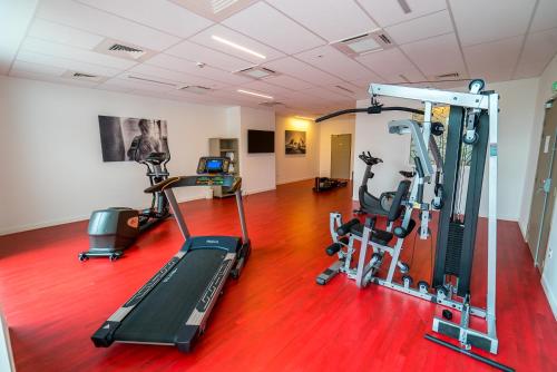 a gym with treadmills and exercise bikes in a room at All Suites Appart Hôtel - Choisy-le-Roi in Choisy-le-Roi