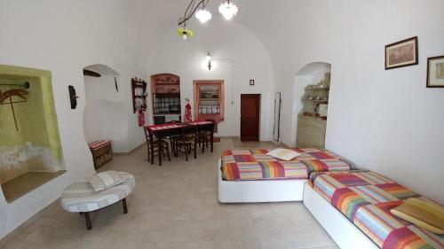 a bedroom with two beds and a dining room at Antica Residenza Estiva in Sannicola