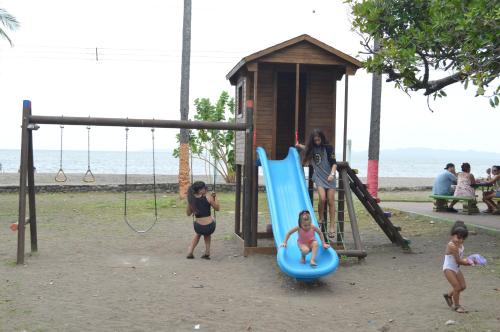 a group of people playing on a playground at Hotel Aldea Pura Vida in Puntarenas