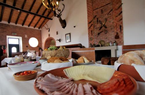 a table with different types of food on it at Turismo Rural Pão e Água in Mértola