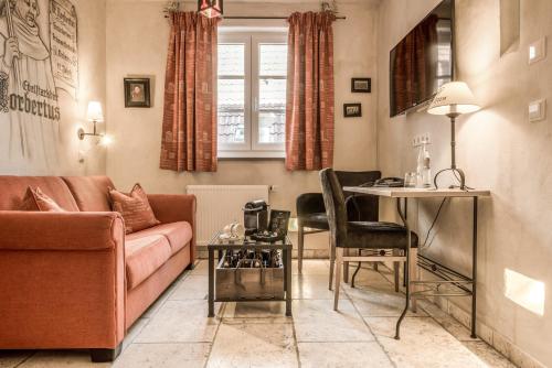 a living room with a couch and a table at Hotel Arthus in Aulendorf