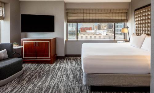 a hotel room with two beds and a television at Hyatt Regency Saint Louis at The Arch in Saint Louis