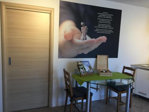 a table and a door with a picture on the wall at CA' del GIACOMINO in Baselga di Pinè