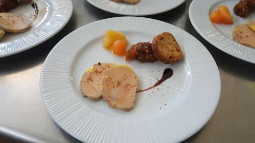 a white plate of food on a table at Logis Cruzel in Maurs