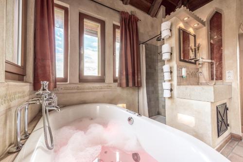 a bathroom with a bath tub with clouds in it at Hotel Arthus in Aulendorf