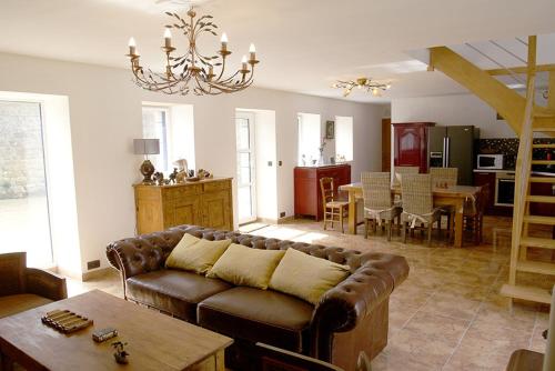 a living room with a couch and a table at La plage a pied in Plouhinec