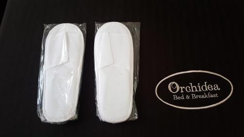 a pair of white shoes in a plastic bag at Orchidea Rooms & Suites in Civitanova Marche