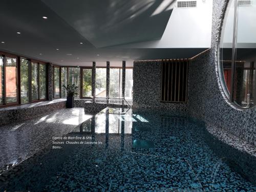 a lobby with a glass floor and a mirror at Logis Le Relais de Fusies in Lacaune