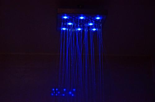 a string of blue lights hanging in the dark at Hotel GreenLand-Elegant in Kolhapur