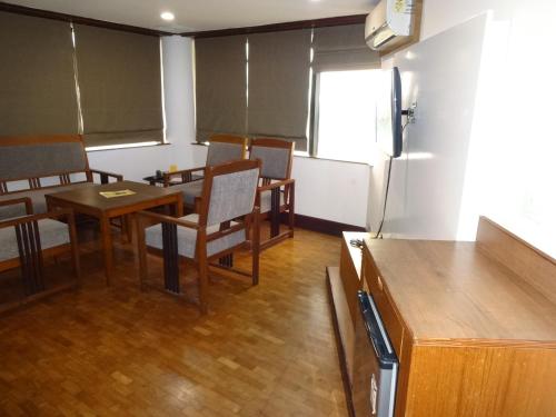 d'une salle à manger avec une table, des chaises et un réfrigérateur. dans l'établissement Keys Select by Lemon Tree Hotels, Malabar Gate, Kozhikode, à Kozhikode