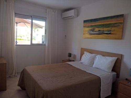 a bedroom with a bed and a painting on the wall at Calahonda Buenavista in Mijas Costa