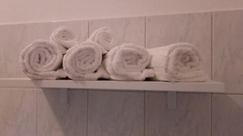 a shelf with towels on it in a bathroom at Apartman Lana in Banjole