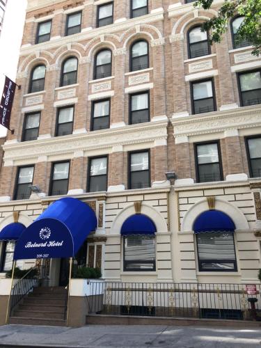 a brick building with two umbrellas in front of it at Belnord Hotel in New York