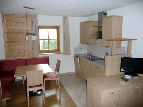 eine Küche mit einem Tisch und einem Esszimmer in der Unterkunft Ferienhaus Staudacher in Brenner