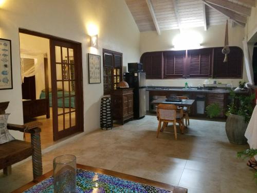 a living room with a kitchen and a table at Villa Touloulou in English Harbour Town
