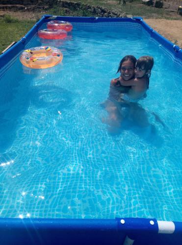 a woman and a child in a swimming pool at Dom Fedorovyh in Sergeyevka
