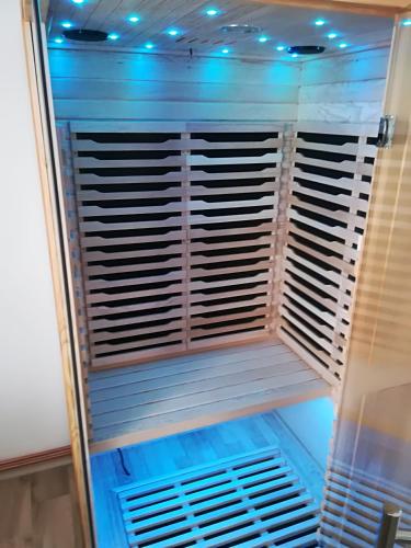 a refrigerator with blue lights in a room at Apartmán Relax Nová Pec Lipno in Nová Pec