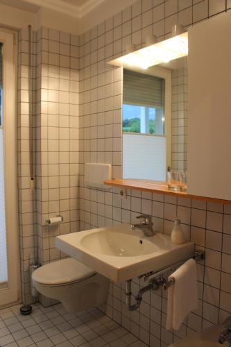 a bathroom with a sink and a toilet and a mirror at Haus Ilse & Karl Heinz in Lasa