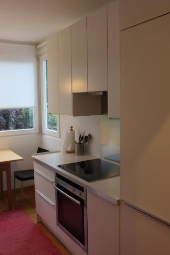 a kitchen with white cabinets and a stove top oven at Haus Ilse & Karl Heinz in Lasa