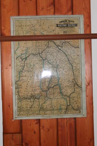 a map is hanging on a wooden wall at Sunny Bluffs Chalets in Kaslo