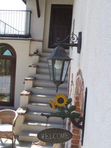 a staircase with a sunflower and a light on it at La Meridiana, monolocale in cascina ristrutturata in Boves
