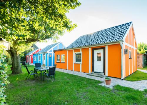 a row of colourful houses in a yard at Haus Windhook in Dierhagen