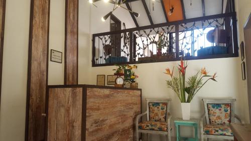a room with a wooden door and two chairs at Rivière Boutique Hotel in Medellín