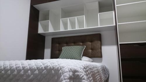 a bedroom with a bunk bed and a green chair at Hotel + Arte in Quito