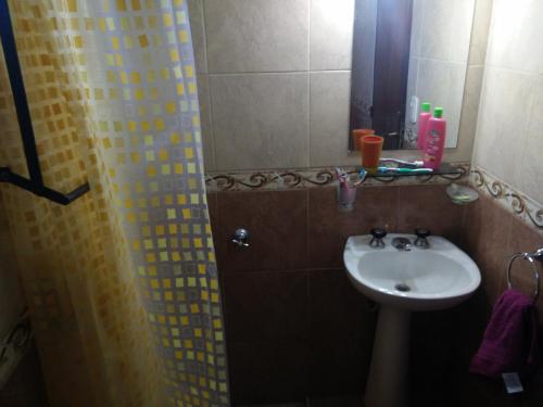 ein Badezimmer mit Waschbecken und Dusche mit Spiegel in der Unterkunft Casa en Santa Rosa de Calamuchita in Santa Rosa de Calamuchita