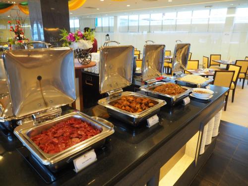a buffet table filled with different types of food at The Klagan Hotel in Kota Kinabalu