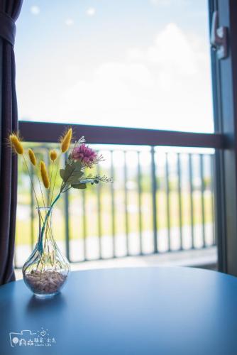 a vase with flowers in it sitting on a table at Simple Life in Yuli