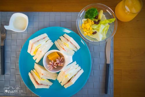 a blue plate with sandwiches and a bowl of food at Simple Life in Yuli
