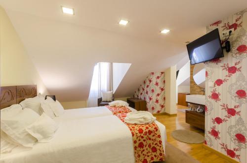 Postel nebo postele na pokoji v ubytování Hotel Borges Chiado