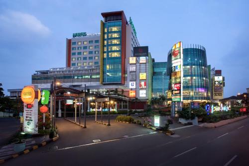a city with tall buildings and a street at night at HARRIS Hotel & Convention Festival Citylink Bandung in Bandung