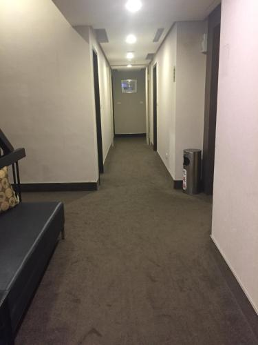 a long hallway with a couch in a room at Royal Hotel in Taipei