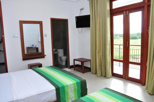 Postel nebo postele na pokoji v ubytování Green View Resort - Anuradhapura