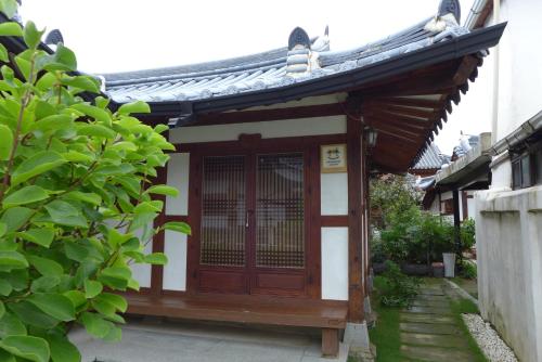 a small building with a gate and a roof at Sarangroo in Jeonju