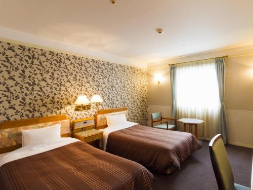Postel nebo postele na pokoji v ubytování Hotel Merieges