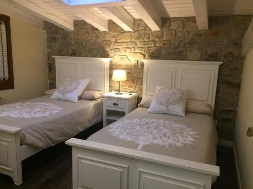 מיטה או מיטות בחדר ב-Casa Rural el Rincon de Maria