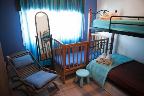 een kamer met 2 stapelbedden, een stoel en een spiegel bij Aquarian Beachfront Apartment in Larnaka