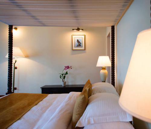 a bedroom with a large bed with white pillows at Galle Face Hotel in Colombo