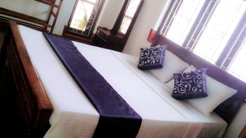 a bed in a room with two pillows on it at Saubagya Inn in Anuradhapura